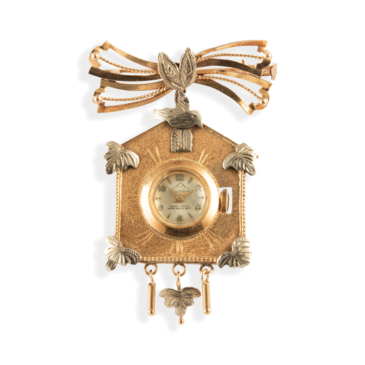 MONDAINE, OROLOGIO-SPILLA A CUCU IN ORO ANNI 50  orologio a spilla a forma di cucu in oro rosso e bi